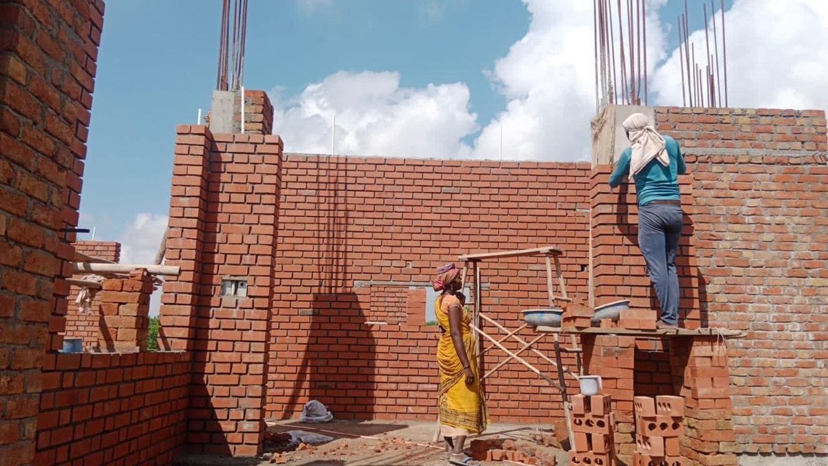 Masons laying BricksStreet wire-cut bricks on a building site